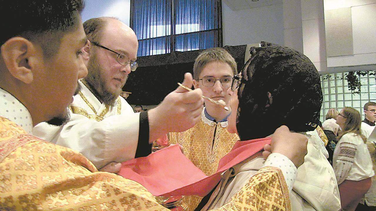 Eastern Catholics receive Holy Communion from a priest, administered by intinction from the chalice with a communion spoon.