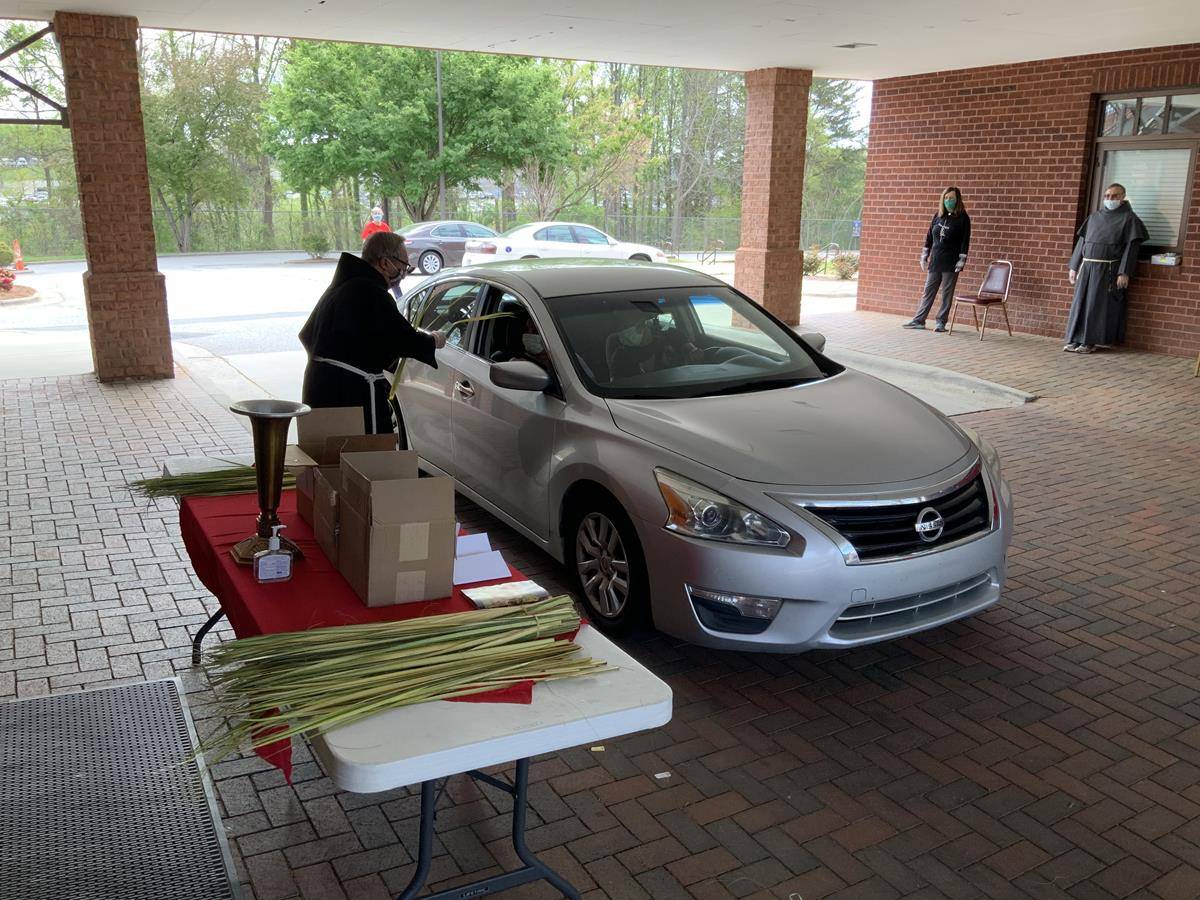 Palm Sunday distribution at Our Lady of Mercy Church in Winston-Salem. (Photo by Alex Moreira, Catholic News Herald)